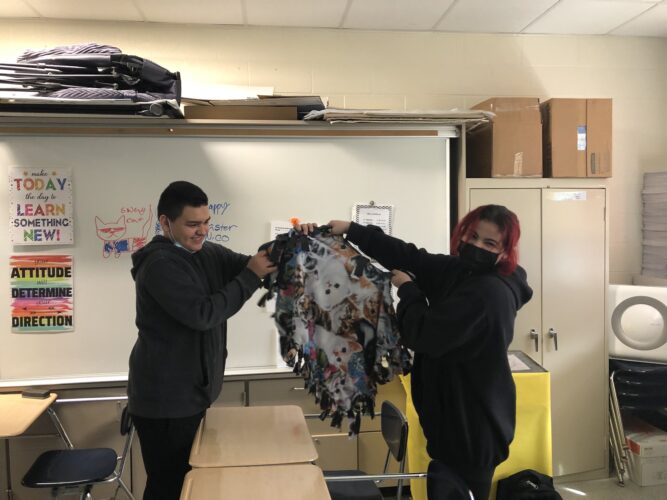 Jazmin Rivera and Aram DeLuna working  on blankets with student council
